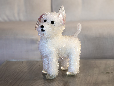 Cashew White dog with a purple raised ear glass sculpture